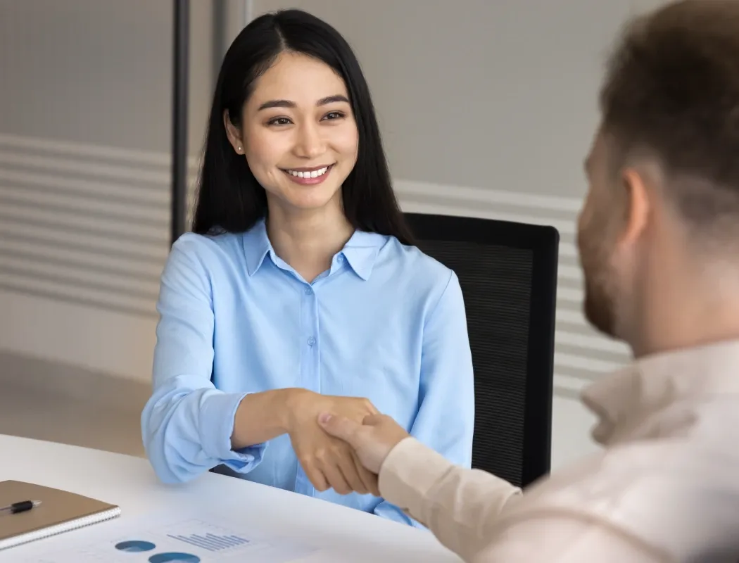 Candidate shaking hands with a recruiter during a job interview at TP.