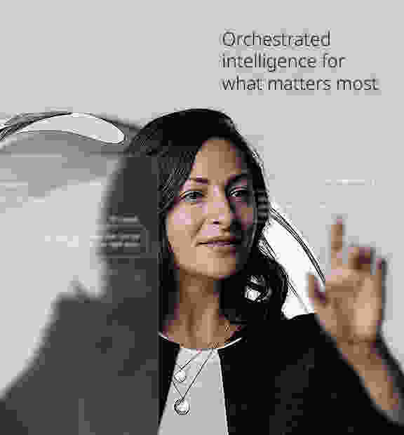 Woman interacting with transparent digital interface displaying AI-generated customer support suggestions, with the text 'Orchestrated intelligence for what matters the most' in the background.