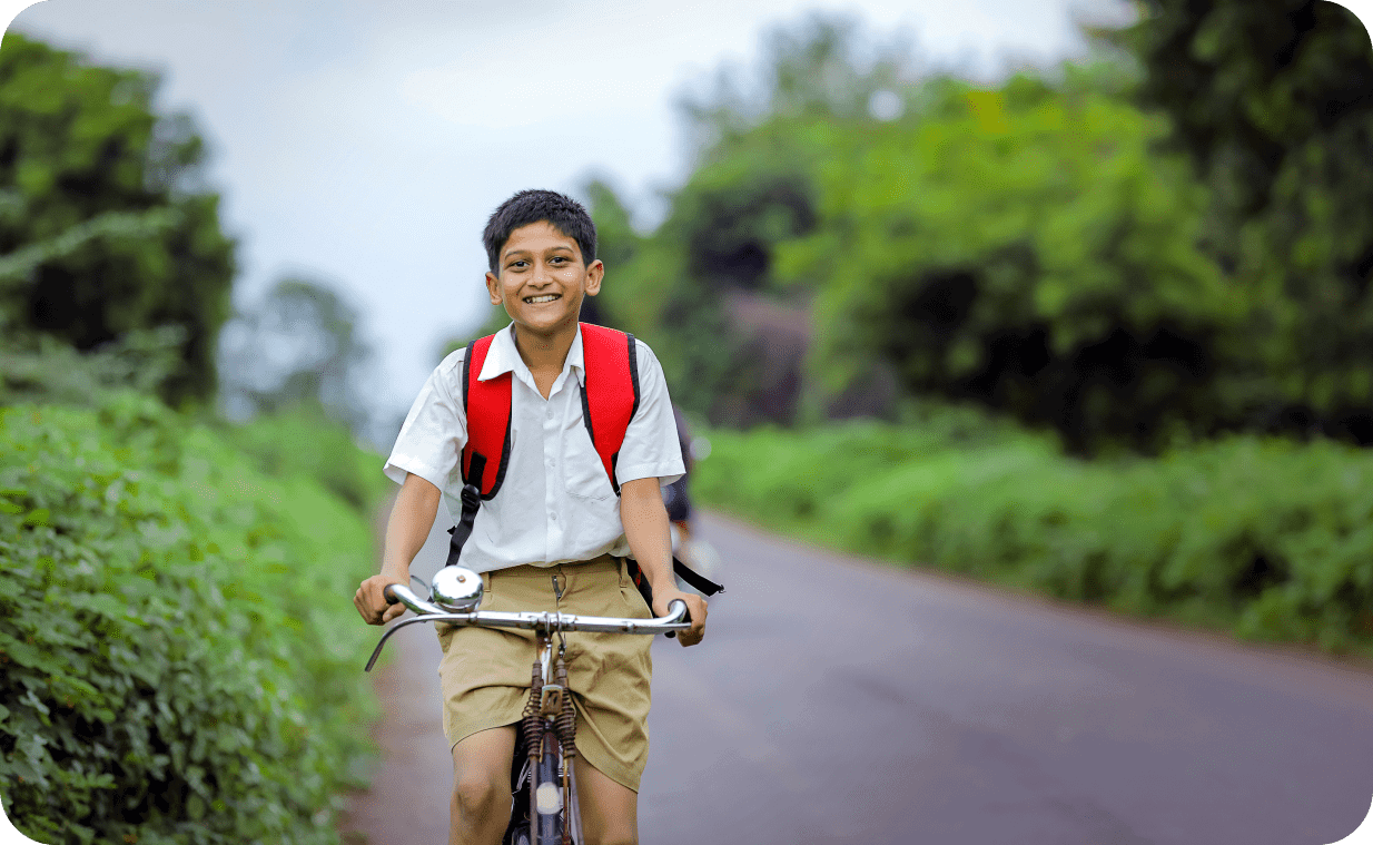 Smiling boy riding a bicycle on the streets
