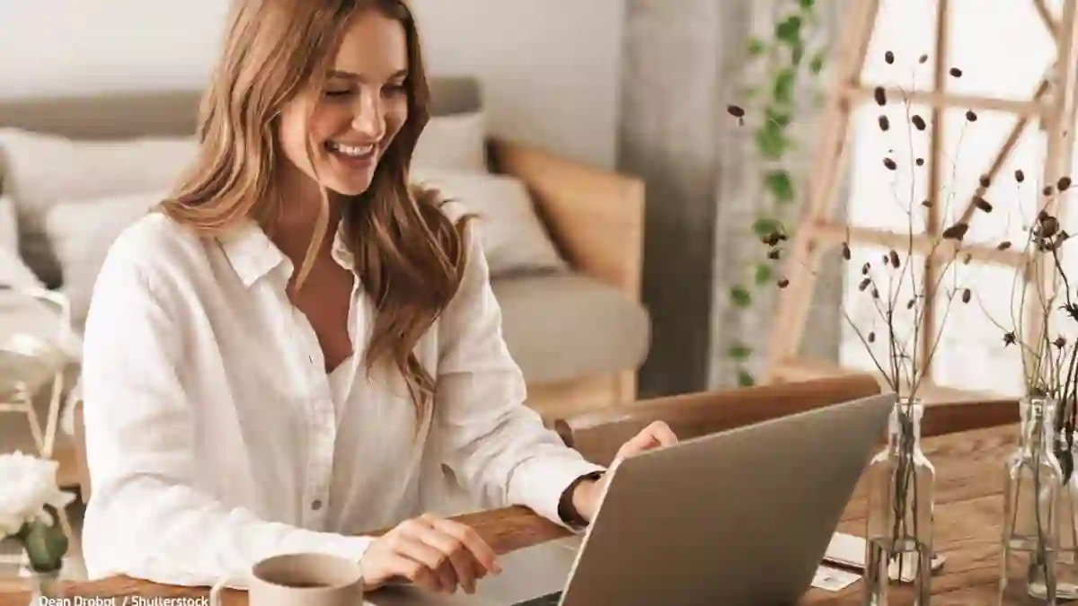 Woman working on her laptop at her modern house