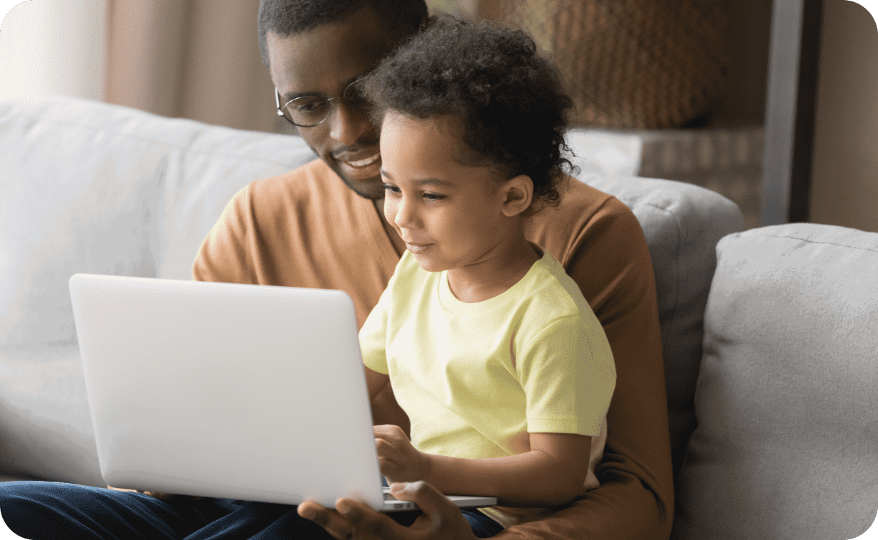 Father and son browsing the web safely on a laptop