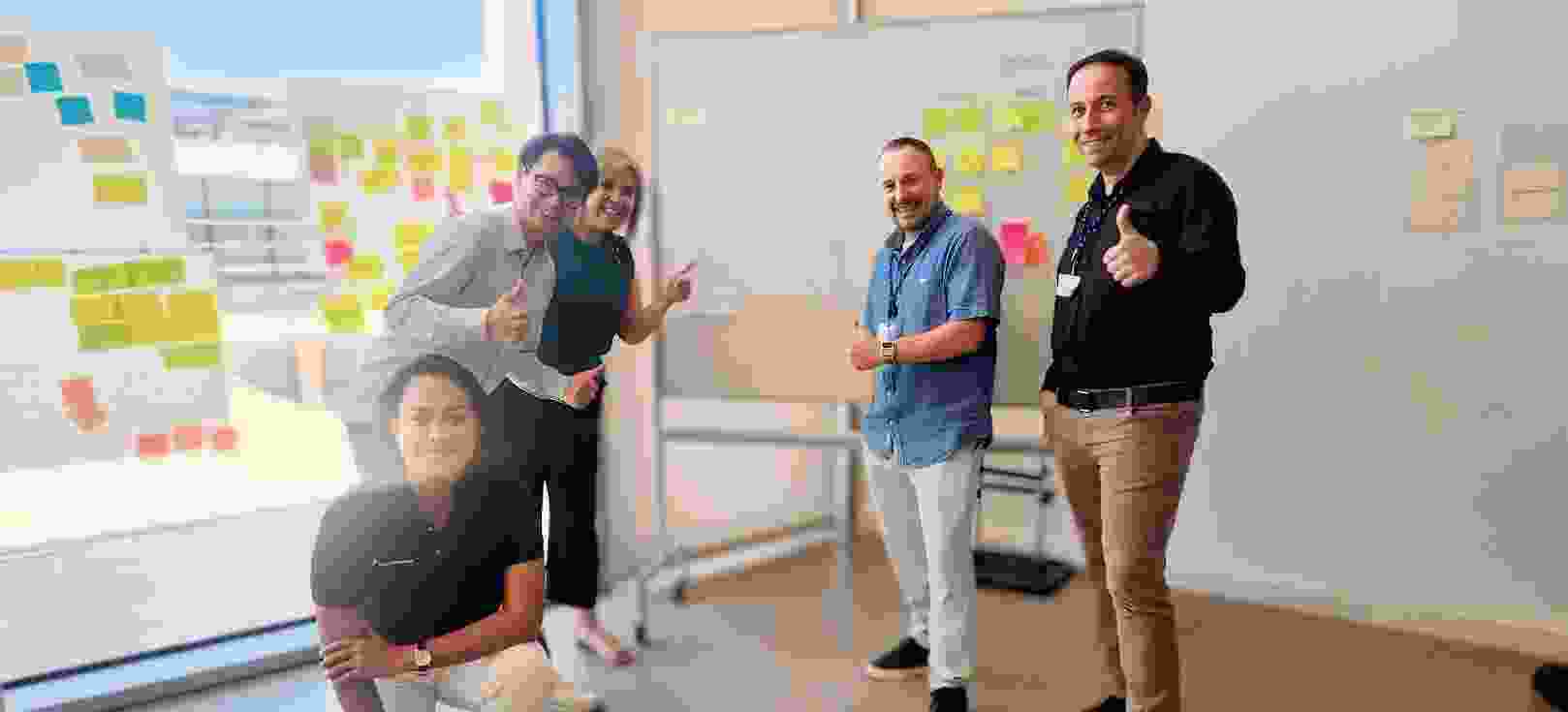 TP employees waving to the camera