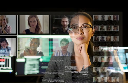 Serious woman wearing glasses in focus with profile pictures and messages on the background