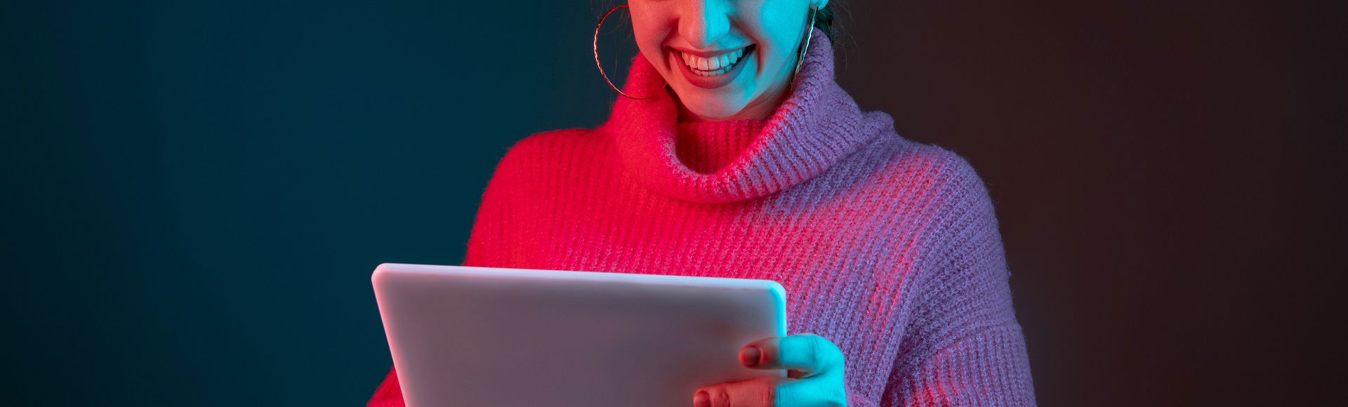 Smiling girl in a pink blouse reading blog articles on her tablet. Smiling girl in a pink blouse reading blog articles on her tablet.
