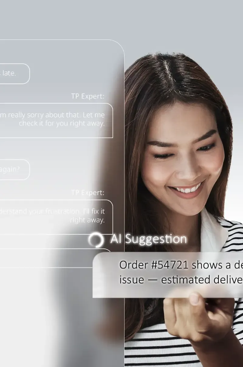 A long-haired female in a striped shirt smiles, head slightly lowered.