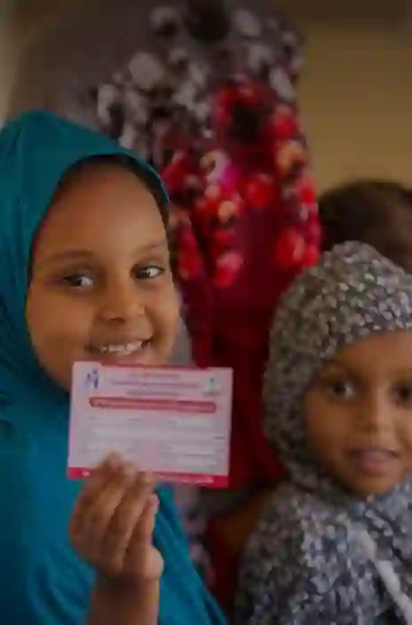 Child holding a card 