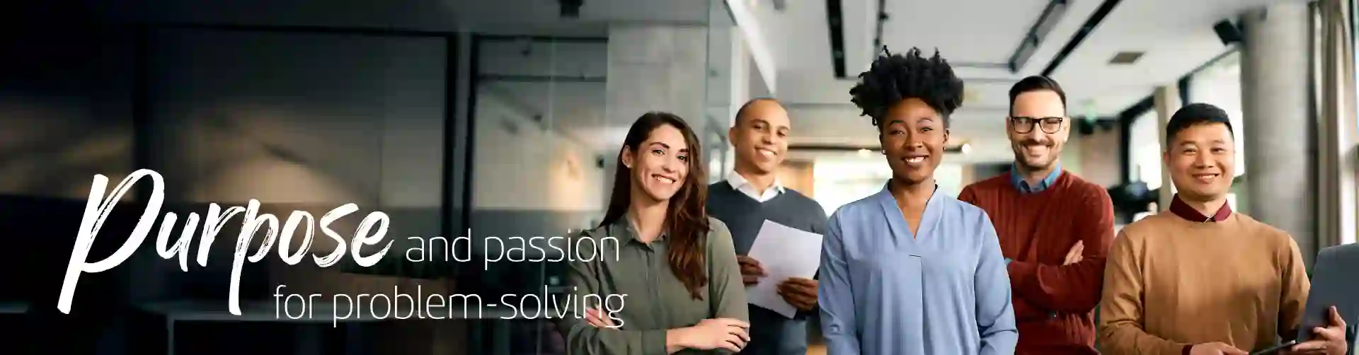 Smiling business people in a modern office staring the camera for a picture