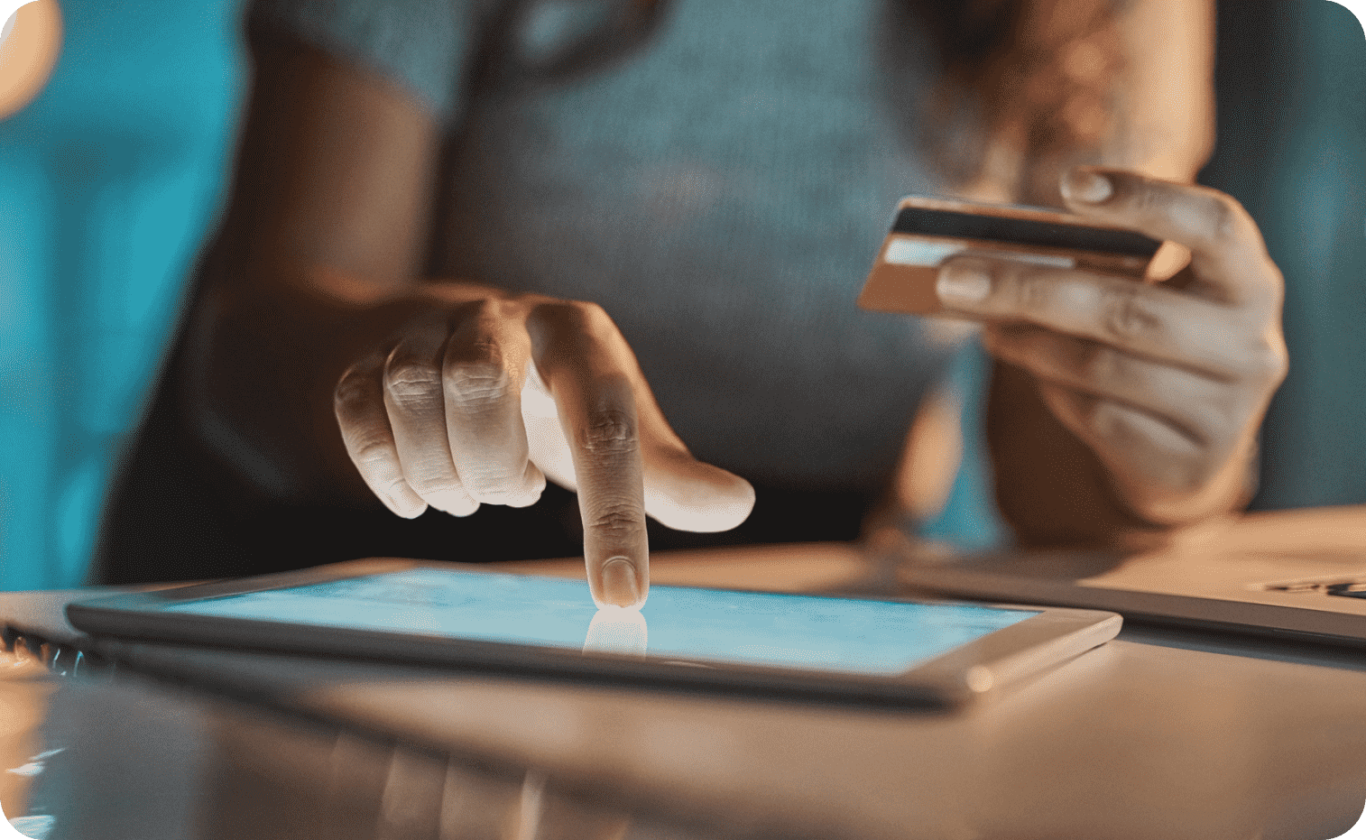 Person holding card to buying online through tablet