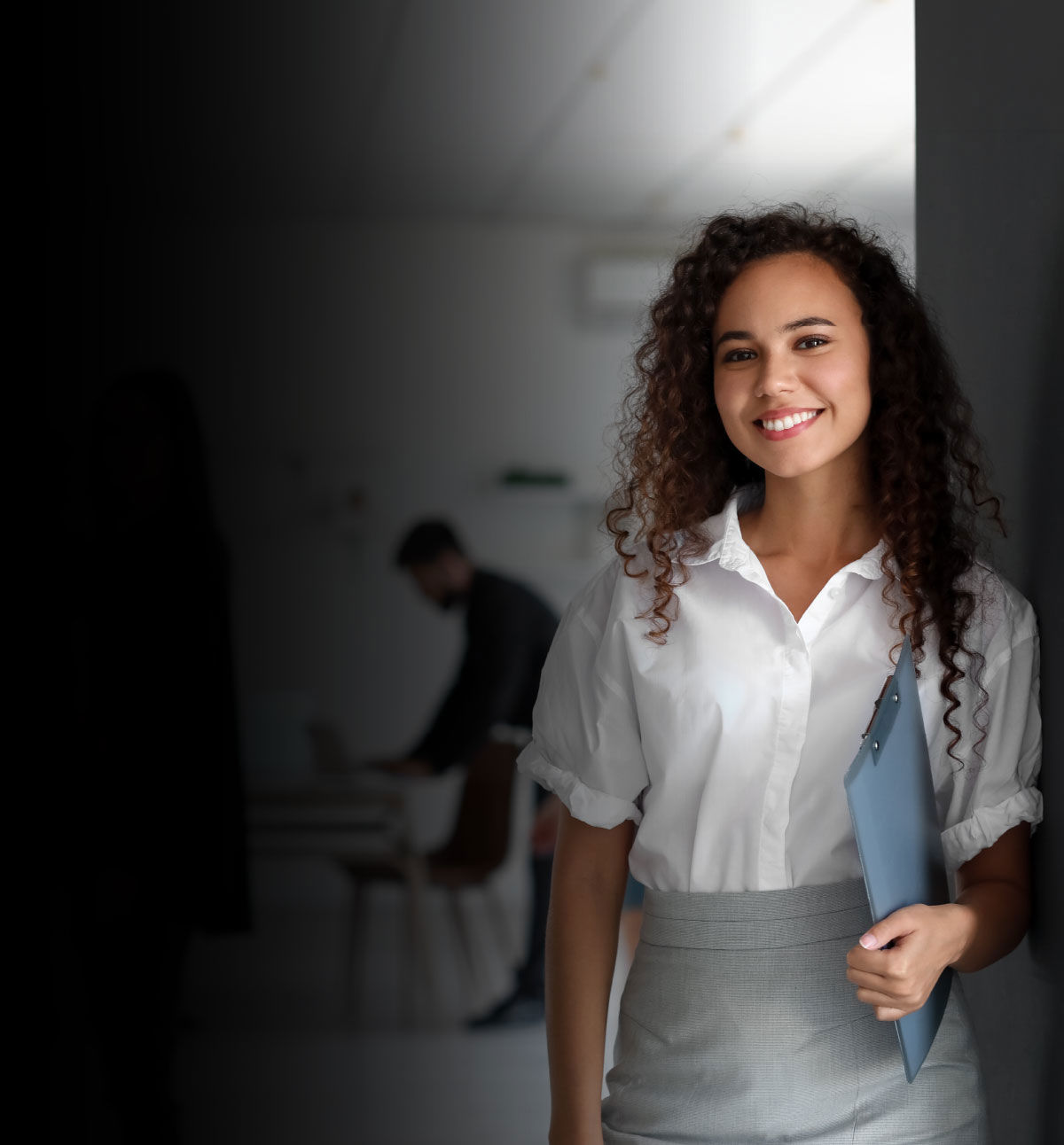 Employees collaborating in a modern open office workspace.