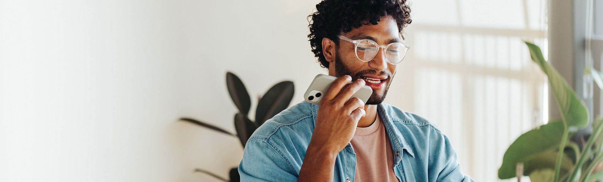 Young man with glasses working on smartphone, blog on TP honored with Frost & Sullivan’s Competitive Strategy Leadership recognition.