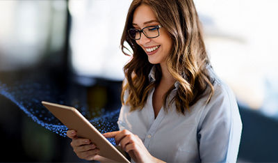Person using a digital tablet with a blurred office-like background.