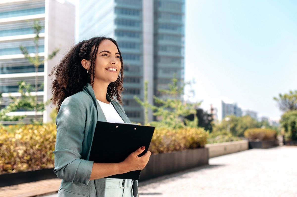 African business woman holding tablet on the street 