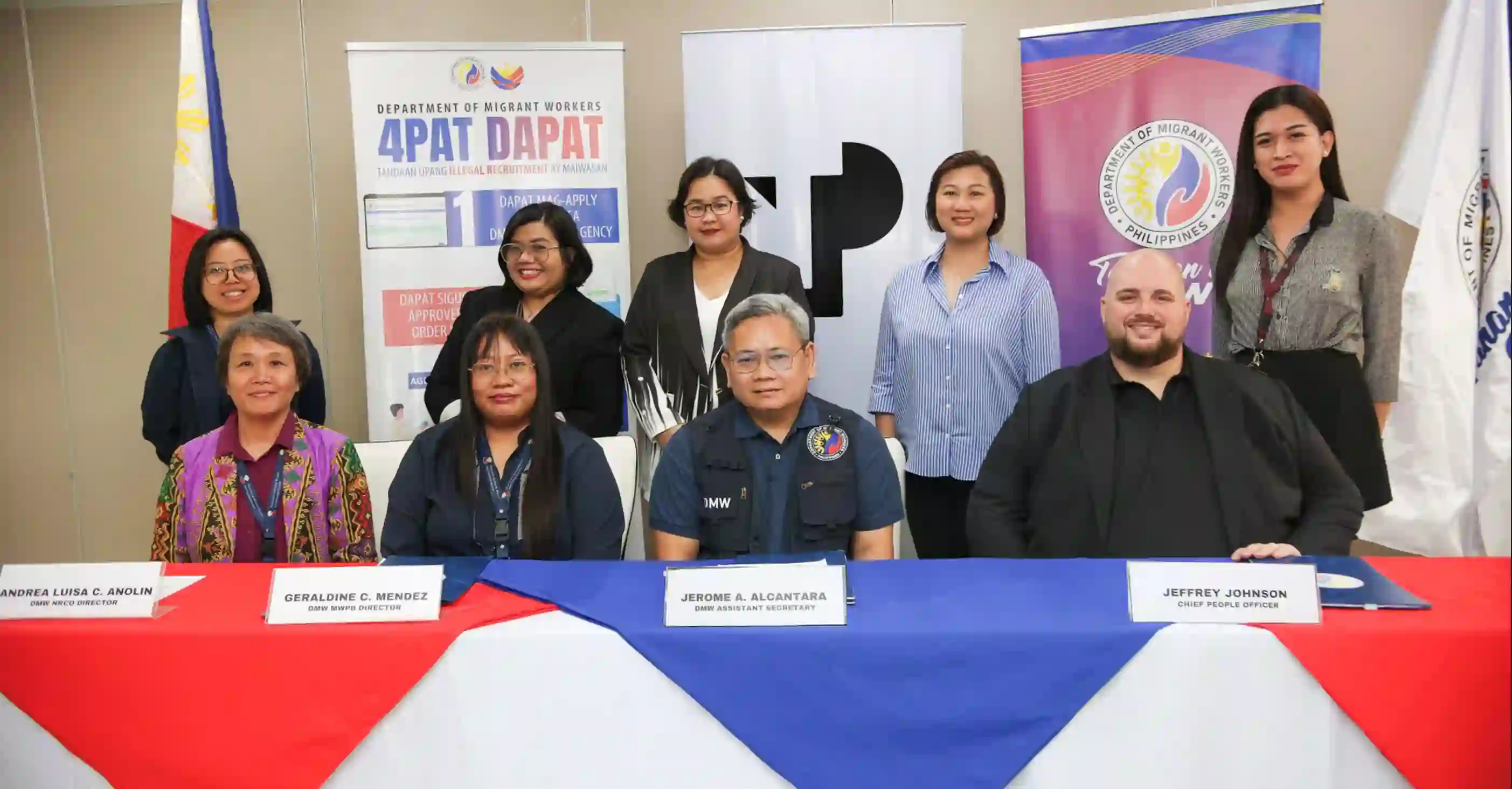 TP and DMW leaders sign MOA for OFW reintegration and anti-trafficking efforts, joined by representatives promoting compassion, inclusivity, and community support.