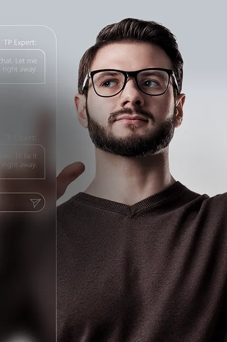 Man with glasses raising his hand beside a digital chat interface.