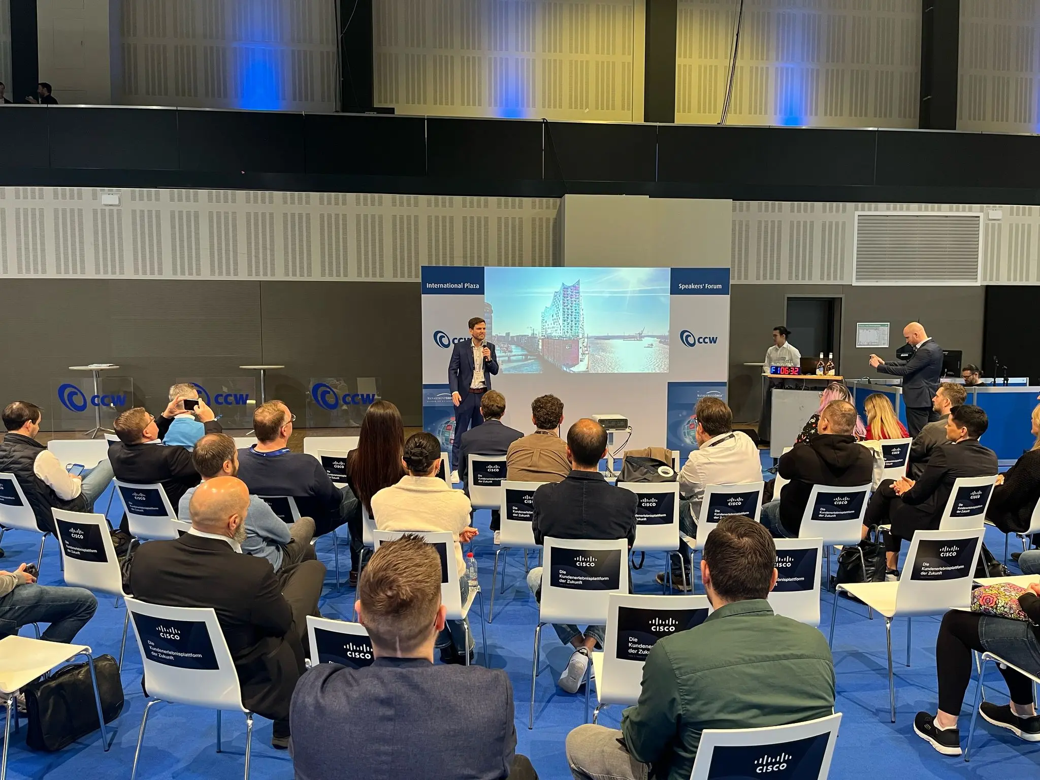 Audience engaged during a keynote presentation at a business and technology conference