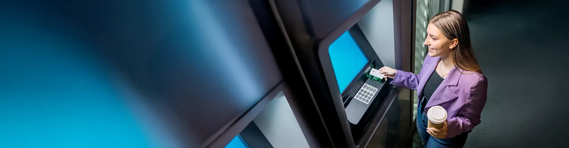 Young woman withdrawing cash from an ATM.