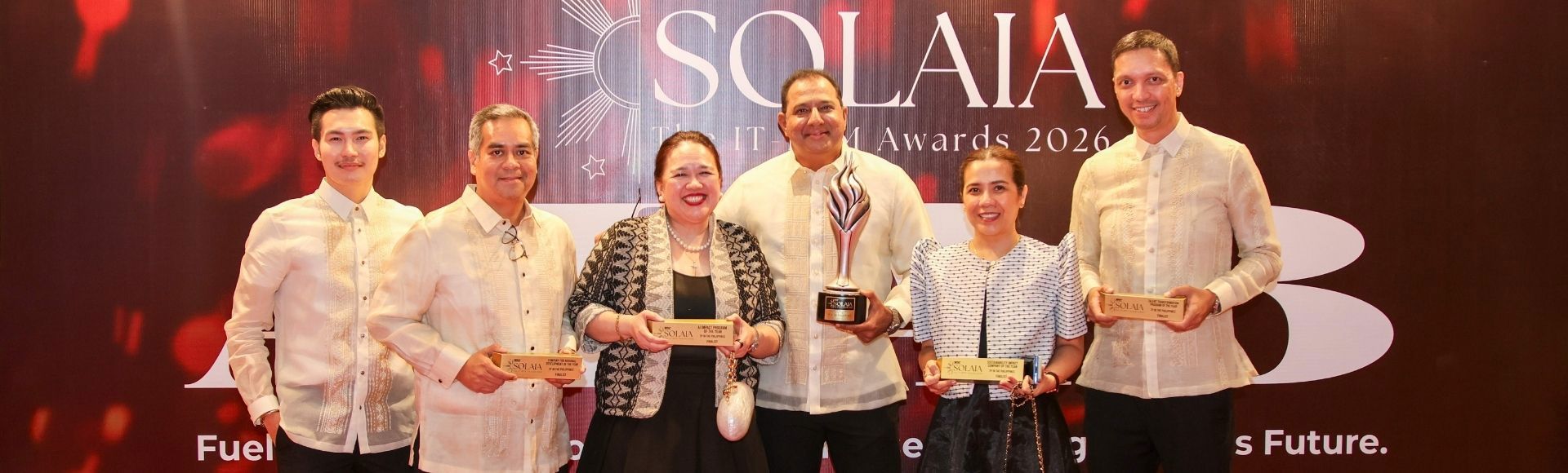 Group photo of smiling TP in the Philippines leaders holding trophies