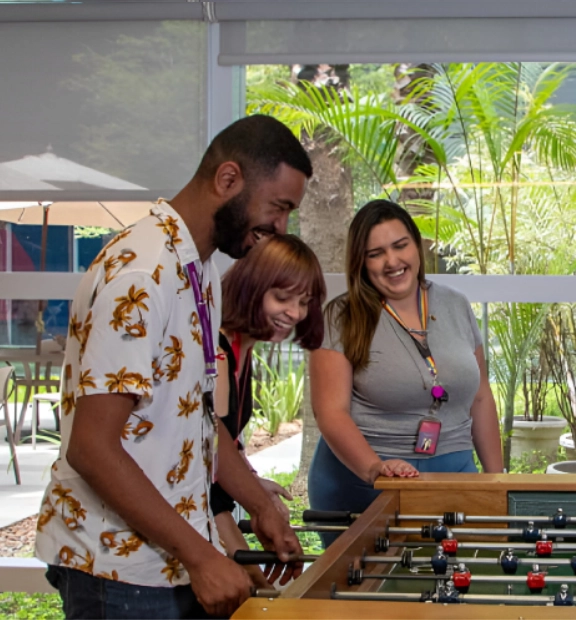 Brazilian employees have fun playing table football