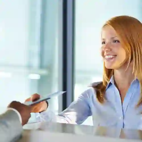Young smiling woman showing documents