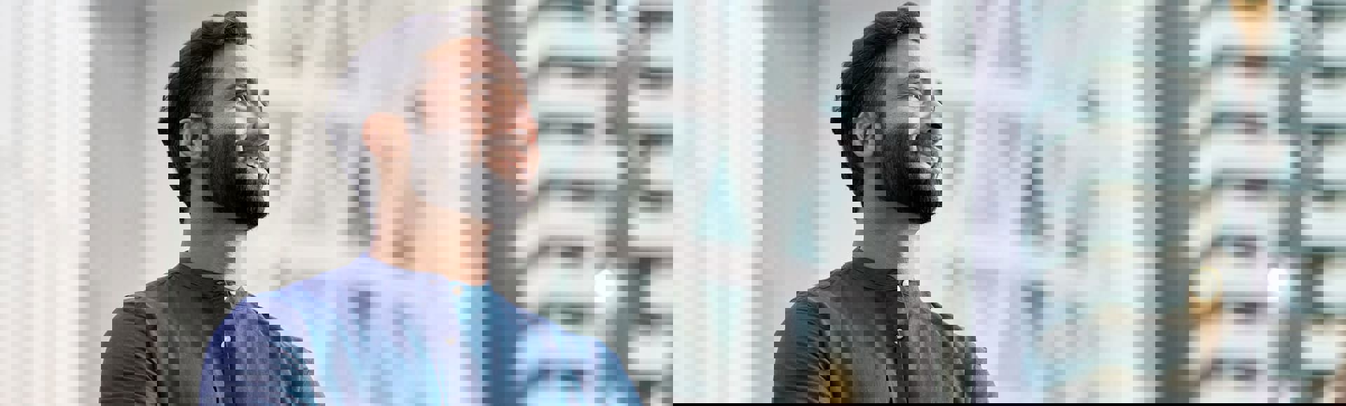 Indian businessman celebrating an award, representing TP’s PR on Frost & Sullivan recognition for CX and digital services.