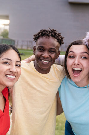 Group of friends hugging each other and smiling