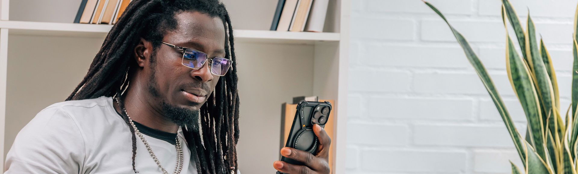 African man using smartphone, illustrating blog about TP as Africa Company of the Year 2025