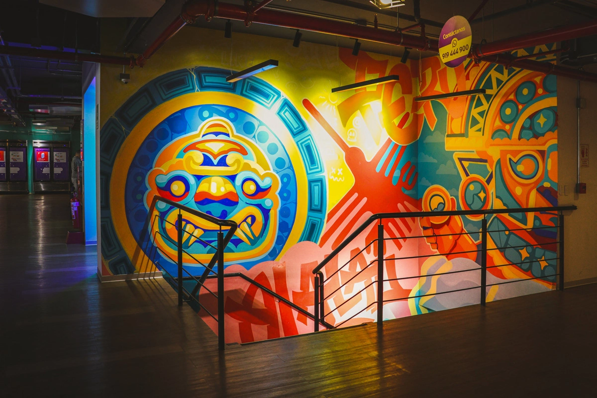 Colorful mural with bold geometric patterns along a staircase in a modern workspace.