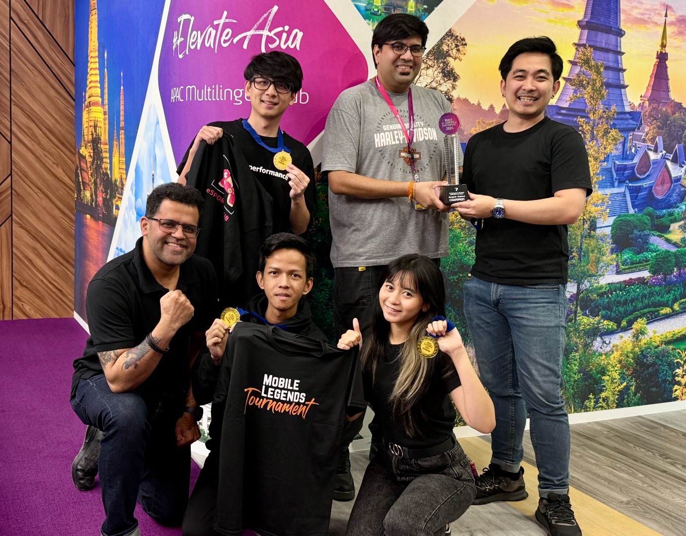 TP employees posing with medals and trophy