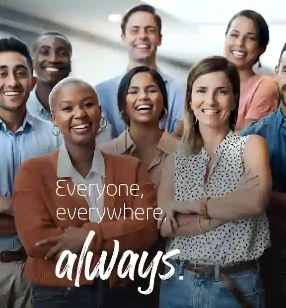 Smiling coworkers looking at the the camera while working in a modern office