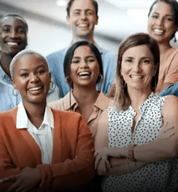 Smiling coworkers looking at the the camera while working in a modern office