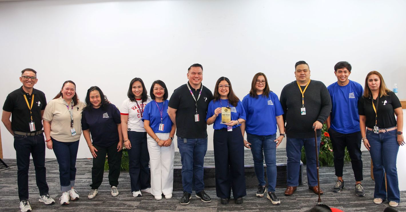 TP team posing with award during anniversary celebration.