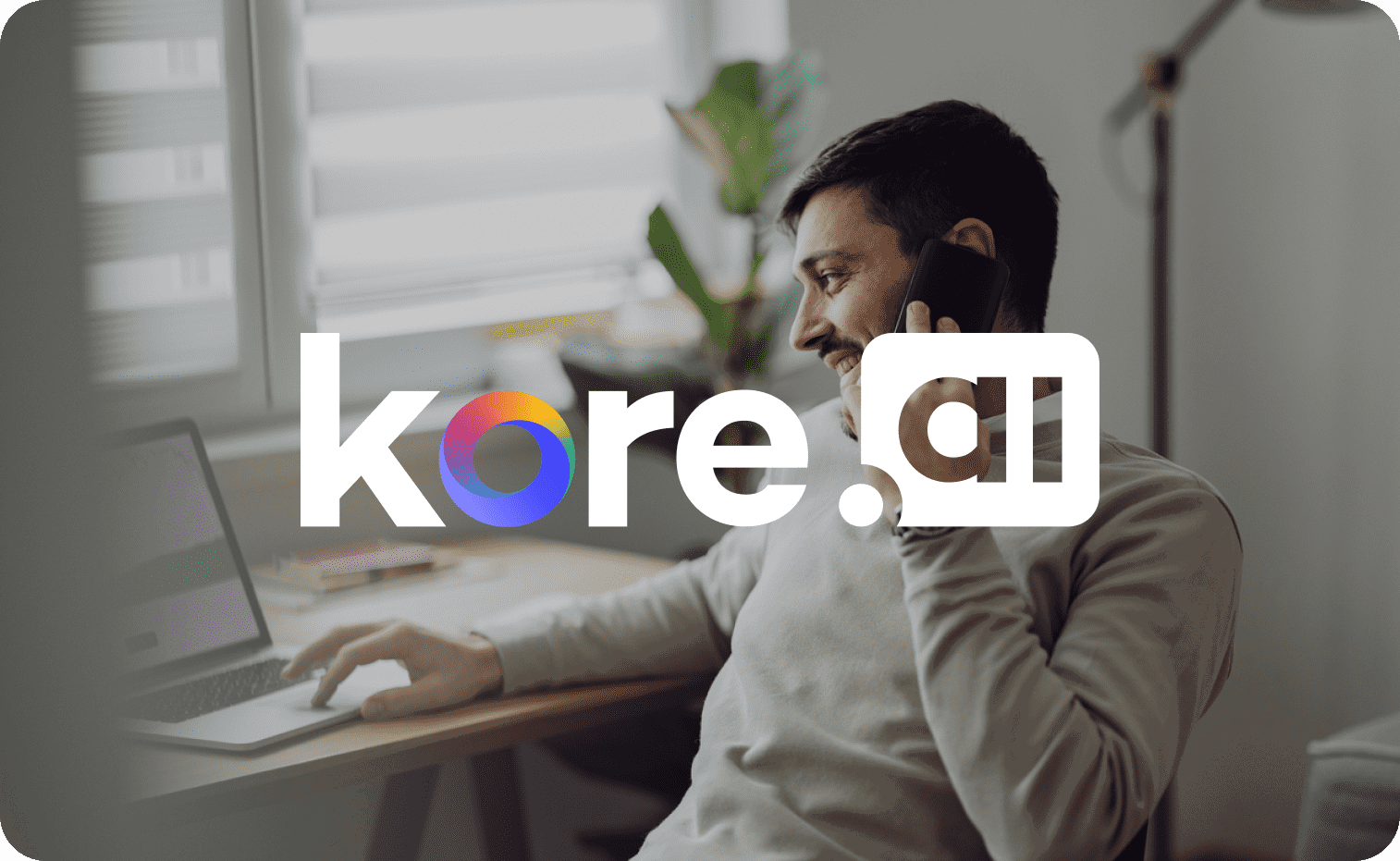 Kore.ai logo in focus with a man talking on the phone in the background Kore.ai logo in focus with a man talking on the phone in the background
