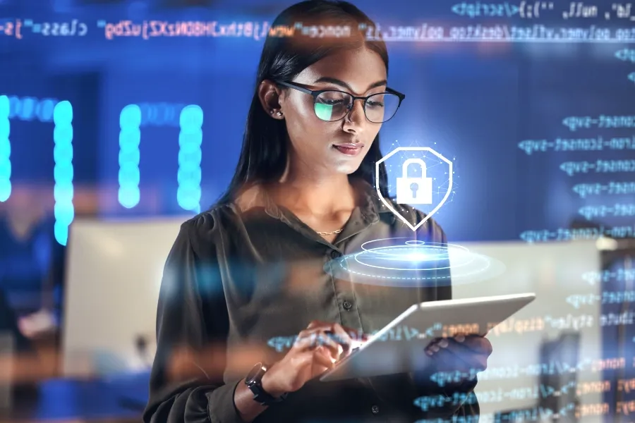 Young developer working on a tablet with code and padlock icon highlighting security.