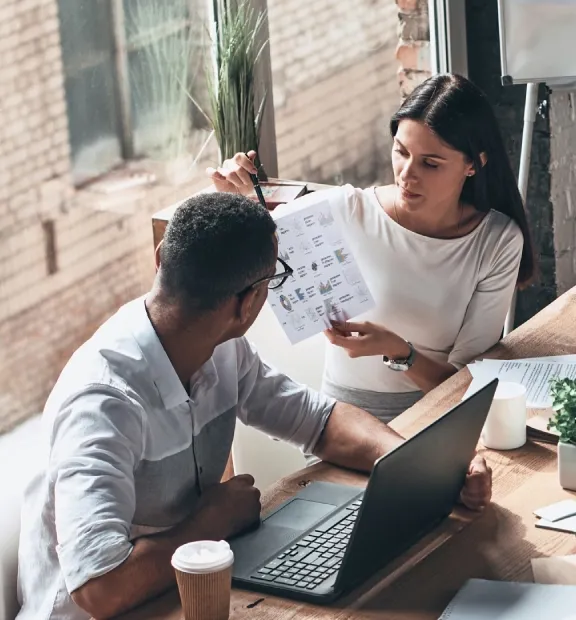 Colleagues gathered around a table during a business meeting.
