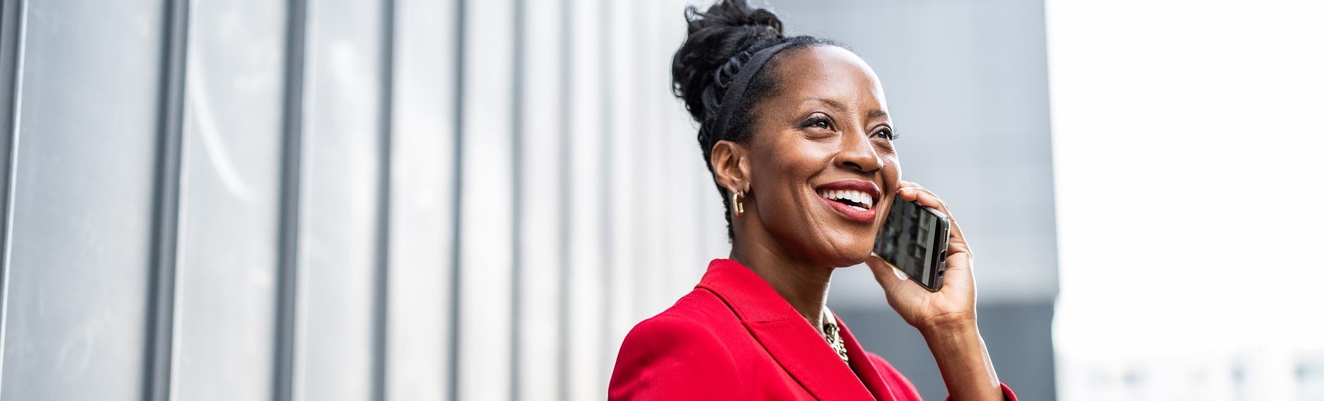 An Afro-descendant businesswoman speaking on the phone.