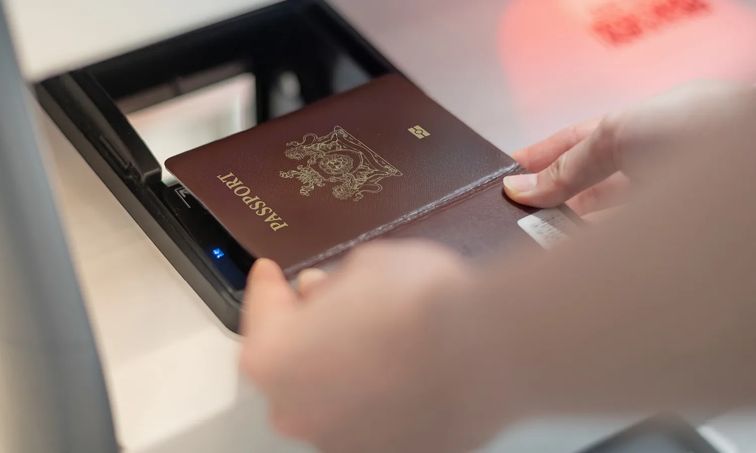 Passport being scanned on a biometric verification device.