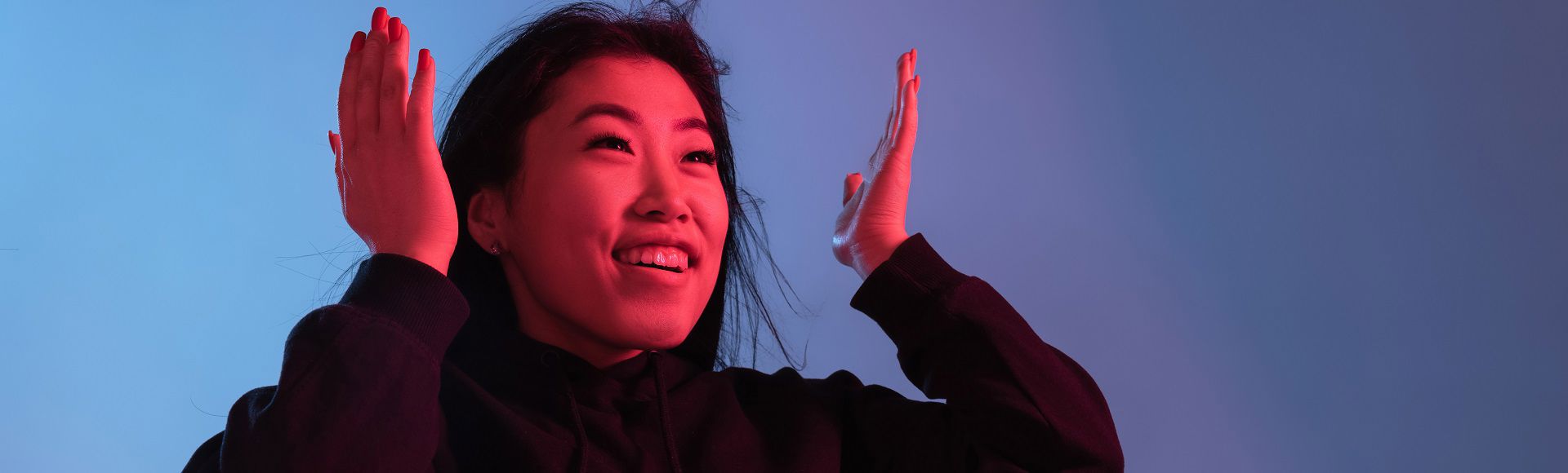 Asian woman with her hands up Asian woman with her hands up