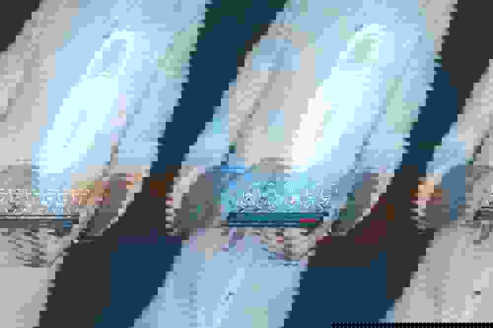 Person holding a tablet with 3D security elements