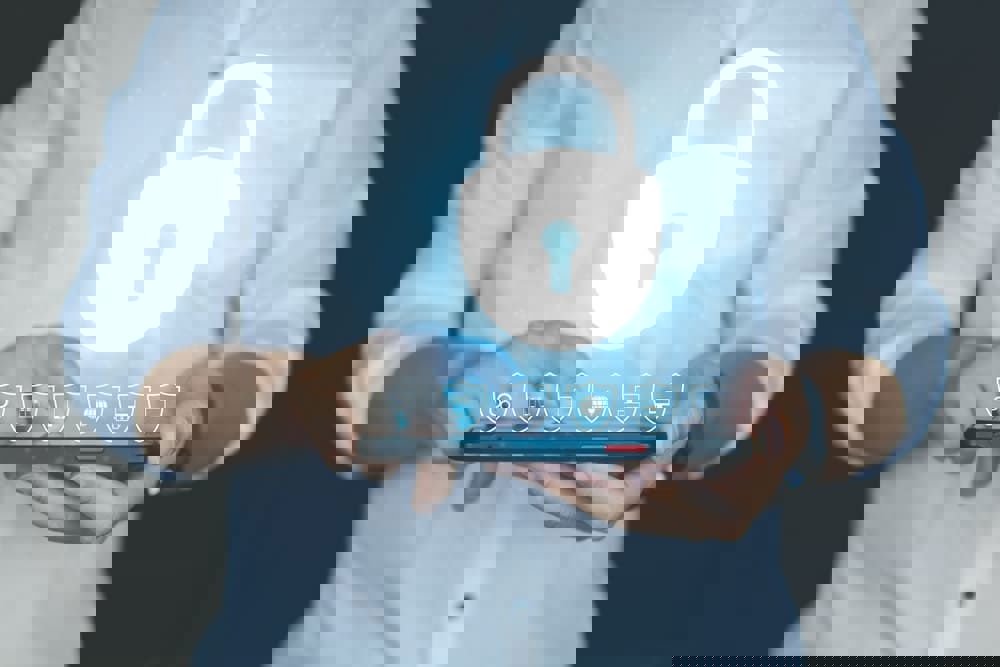 Person holding a tablet with 3D security elements