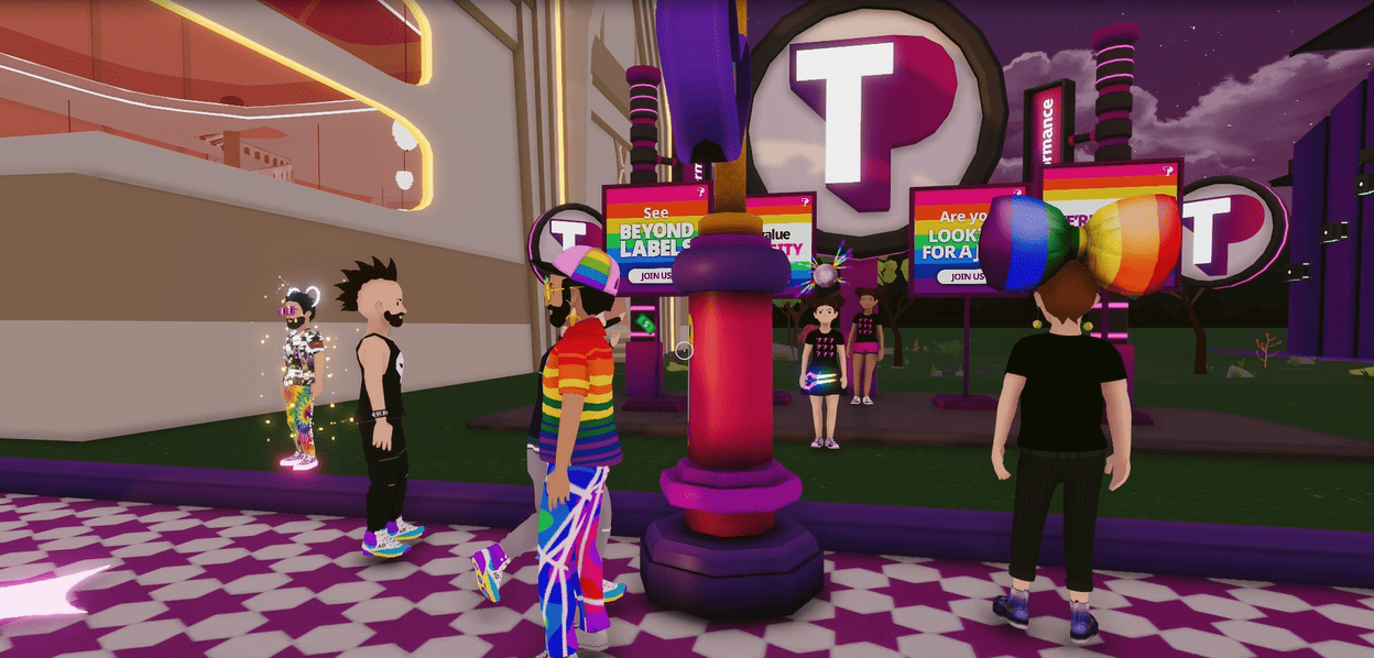 Avatars in a Pride-themed metaverse recruitment area, with rainbow outfits and accessories, standing in front of colorful signs that read ‘See beyond labels,’ ‘We value diversity,’ and ‘Are you looking for a job?,’ alongside the large TP logo.