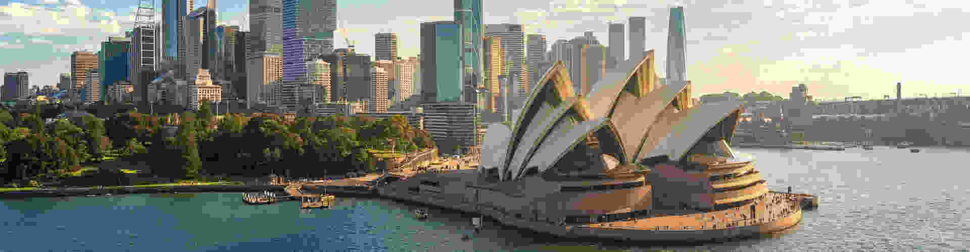 Aerial view of the beautiful and modern city of Sydney, featuring the iconic Opera House on a sunny day.