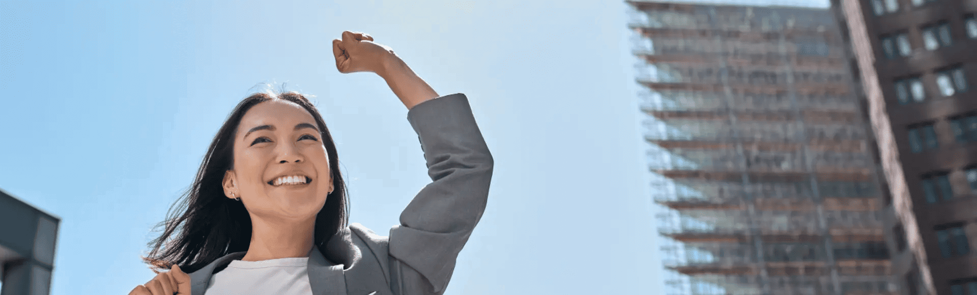 Asian businesswoman celebrating, representing TP topping the Frost Radar™ for innovation and growth in APAC.