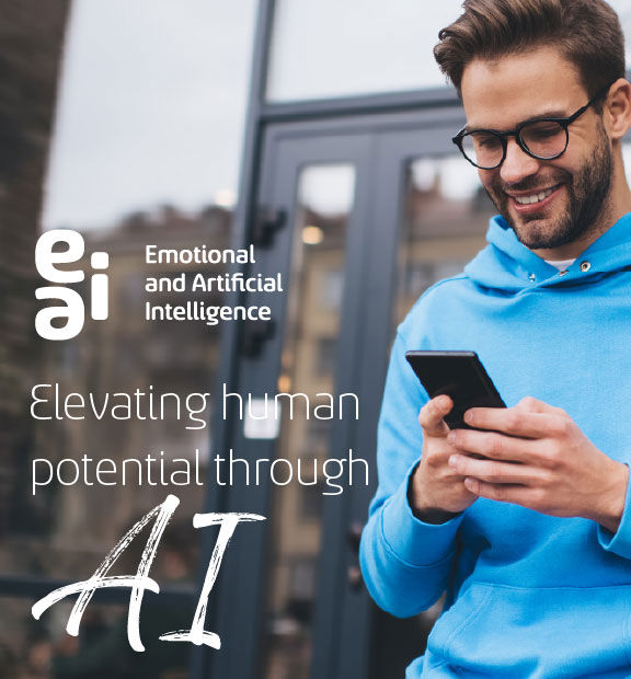 Smiling young man on the balcony of an office browsing his cell phone