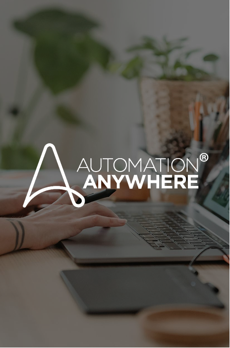 Automation Anywhere logo in focus and person typing in the background Automation Anywhere logo in focus and person typing in the background